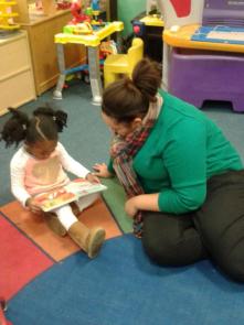 UDM student Chantel Ellis reads an RX for Reading book with a Peggy's Place preschooler.