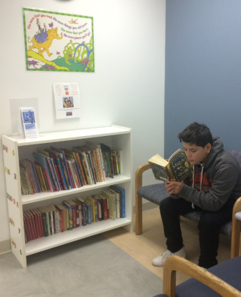 José reading while he waits for his appointment